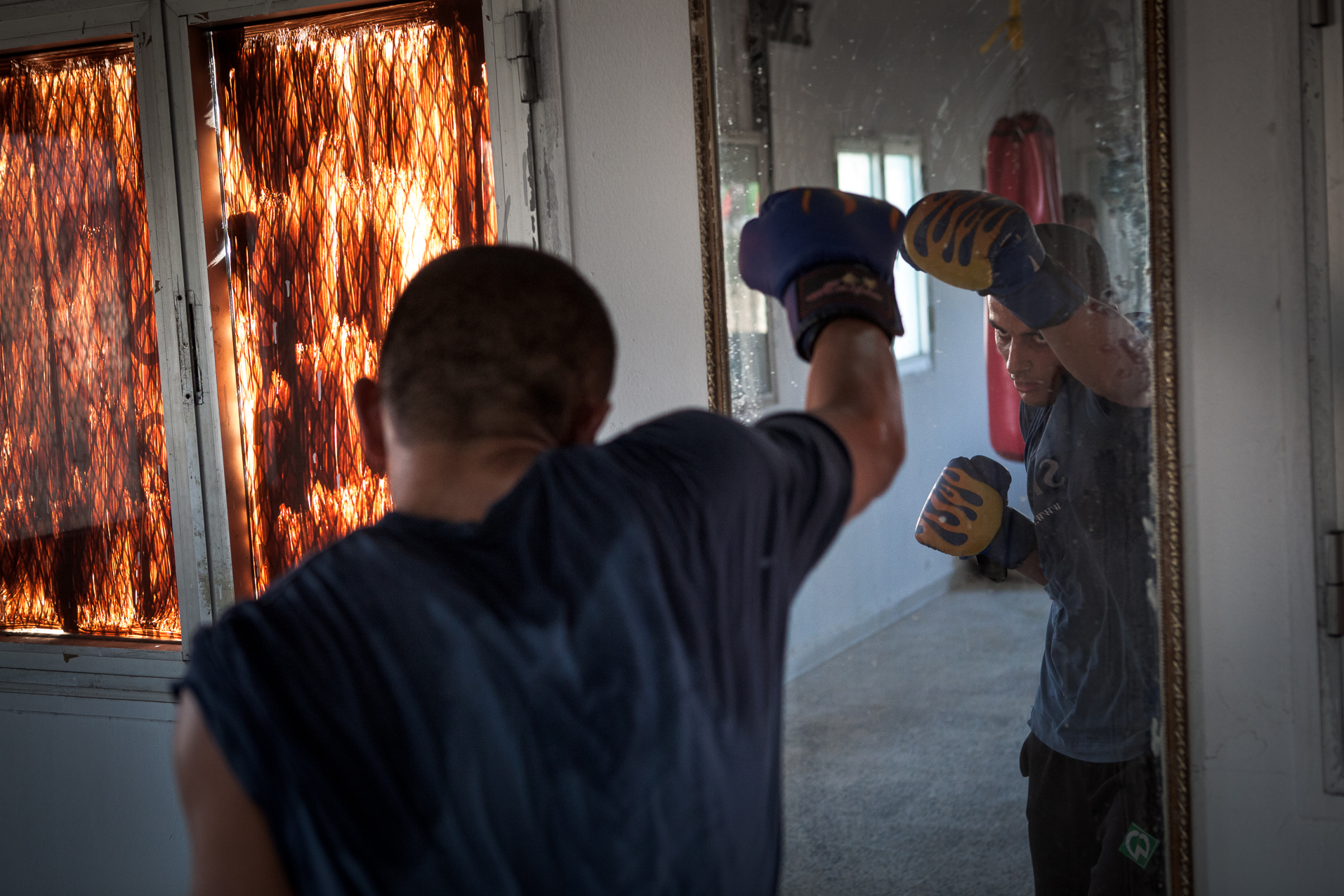 Tripoli, Juillet 2012. Interdite depuis 1979 par Muammar Kadhafi qui trouvait ce sport "sauvage", la boxe revient en Libye. Les jeunes de ce quartier du sud Ouest de Tripoli s'entrainent sous la houlette d'anciens champions.
Tripoli, July 2012. Prohibited since 1979 by Muammar Gaddafi, boxing returns to Libya. Young people of this district in the south west of Tripoli are training under the guidance of former champions.